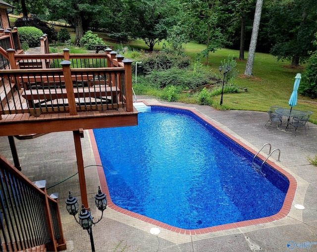 view of pool with a lawn, a patio area, and a deck