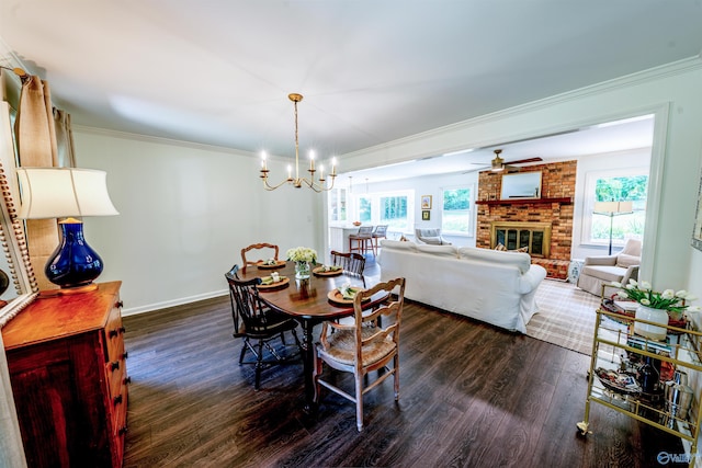 218 Beaver Run Dr, Madison, AL 35758 - dining space with dark wood-type flooring, crown molding, a fireplace, a chandelier, and baseboards