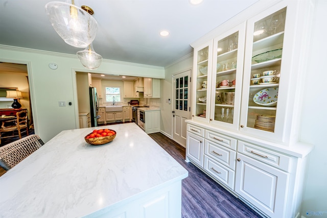 218 Beaver Run Dr, Madison, AL 35758 - kitchen with appliances with stainless steel finishes, crown molding, dark wood finished floors, glass insert cabinets, and white cabinetry