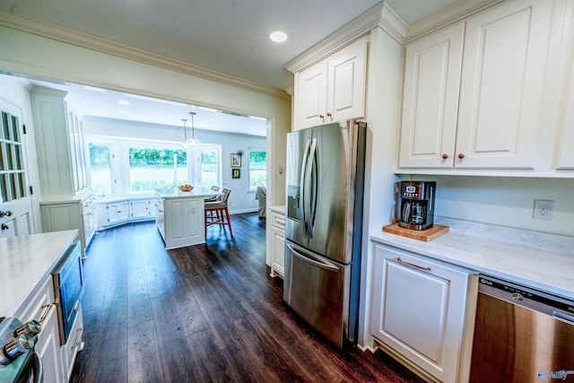 218 Beaver Run Dr, Madison, AL 35758 - kitchen with stainless steel appliances, dark wood-style flooring, ornamental molding, white cabinetry, and light stone counters