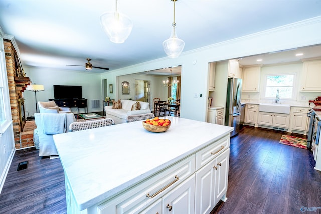 218 Beaver Run Dr, Madison, AL 35758 - kitchen featuring stainless steel fridge with ice dispenser, a sink, light countertops, a brick fireplace, and open floor plan