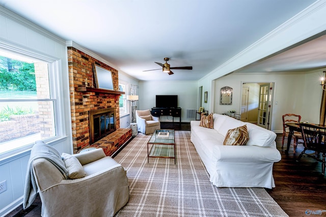 218 Beaver Run Dr, Madison, AL 35758 - living area featuring healthy amount of natural light, a ceiling fan, a fireplace, wood finished floors, and ornamental molding