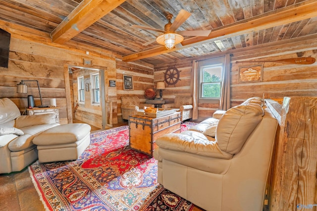 living room with beamed ceiling, wood walls, wooden ceiling, and ceiling fan