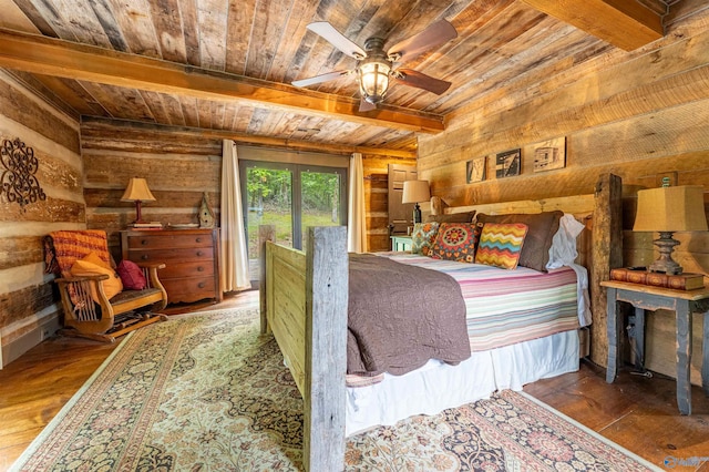 bedroom with wood walls, wooden ceiling, beam ceiling, and hardwood / wood-style floors