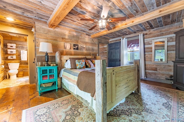 bedroom with wooden walls, beam ceiling, wood ceiling, and hardwood / wood-style floors
