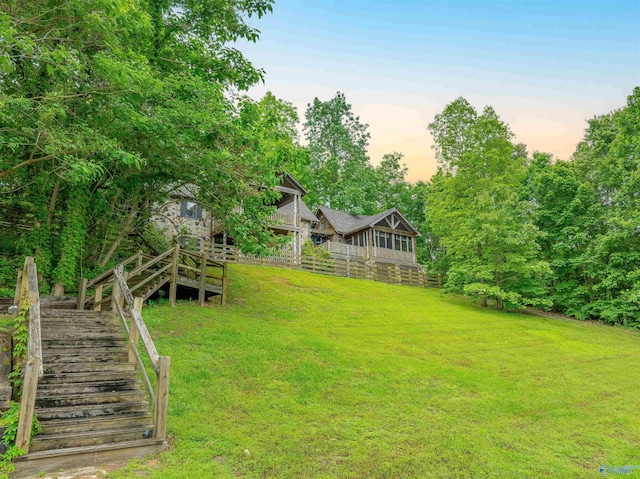view of yard with a wooden deck and stairway