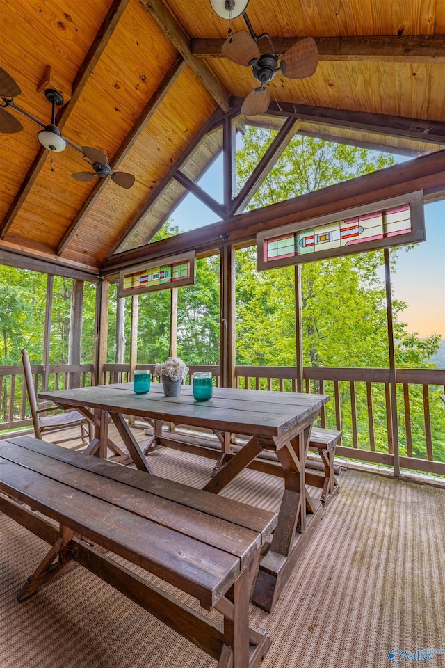 sunroom / solarium featuring a ceiling fan and outdoor dining space