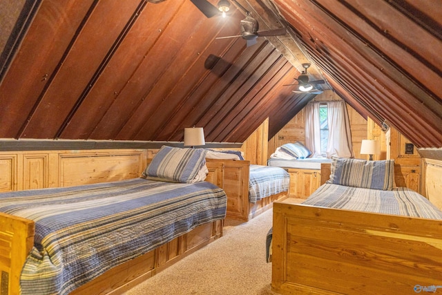 bedroom with carpet flooring, ceiling fan, lofted ceiling, and wooden walls
