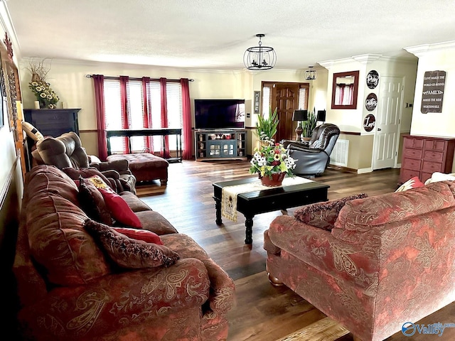 living room with ornamental molding, a textured ceiling, and wood finished floors
