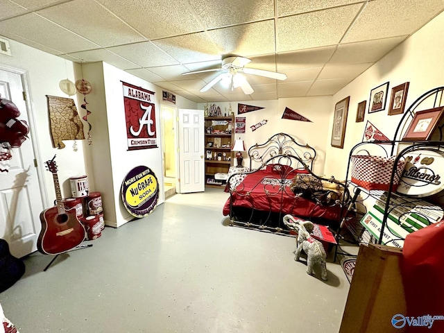 bedroom featuring concrete floors, visible vents, and a drop ceiling