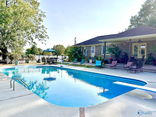 view of pool featuring a patio, fence, french doors, and a fenced in pool