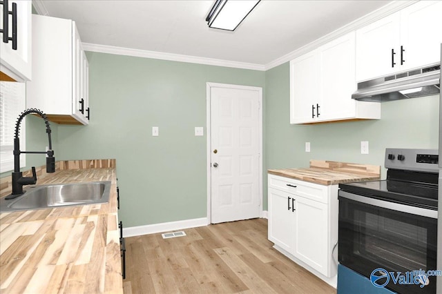 kitchen featuring sink, white cabinetry, stainless steel range with electric cooktop, and wooden counters