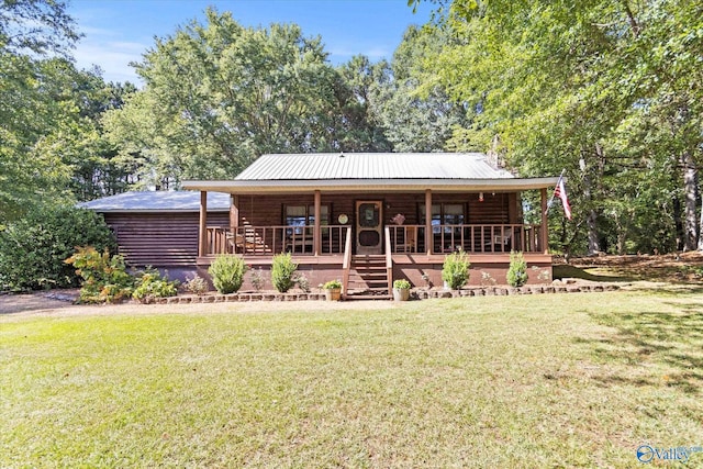 log-style house with a front yard and covered porch