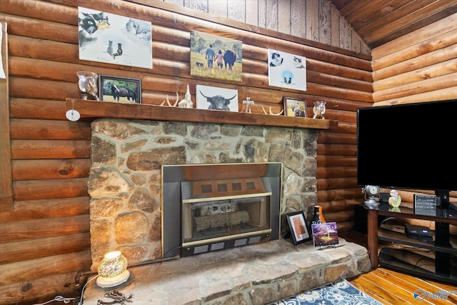 details with a stone fireplace and log walls