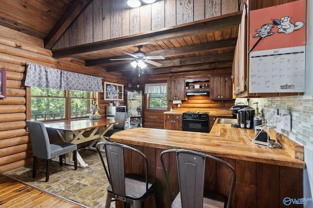 kitchen with wooden counters, rustic walls, range, beam ceiling, and wooden ceiling