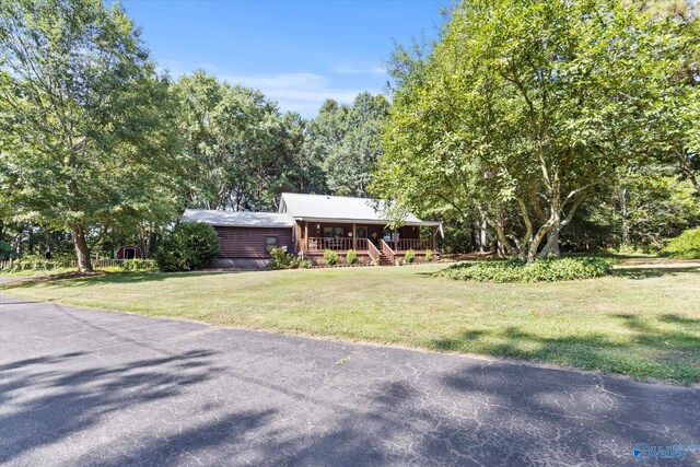 view of front of home with a porch and a front yard