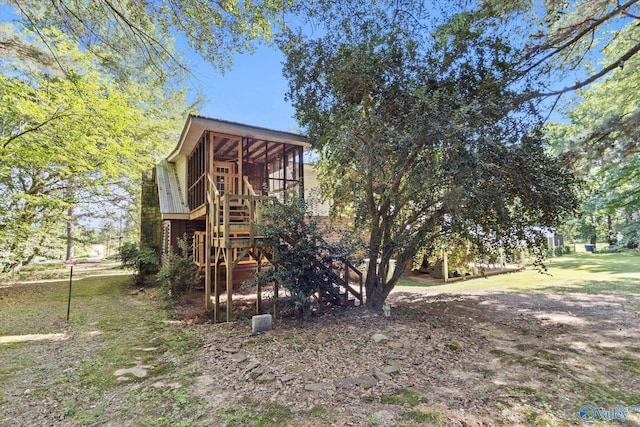 rear view of house featuring a sunroom