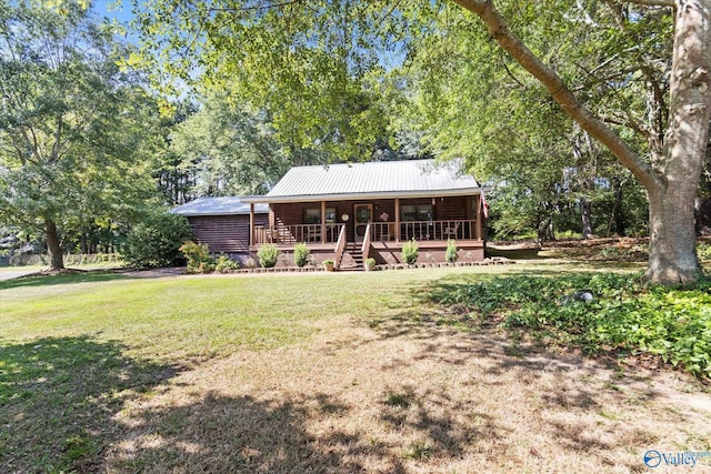 back of property with a yard and covered porch