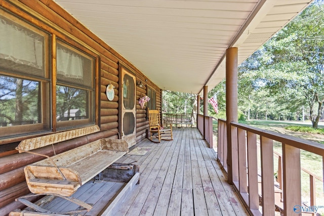 wooden terrace featuring covered porch