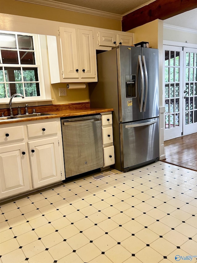 1727 SW Chestnut Mountain Rd, Decatur, AL 35603 - kitchen featuring appliances with stainless steel finishes, a sink, light floors, crown molding, and dark countertops