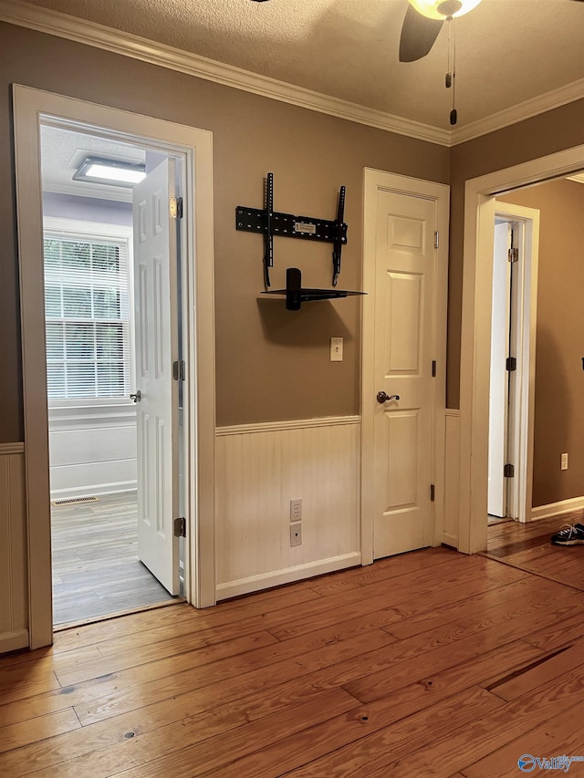 1727 SW Chestnut Mountain Rd, Decatur, AL 35603 - interior space with hardwood / wood-style flooring, a wainscoted wall, and crown molding