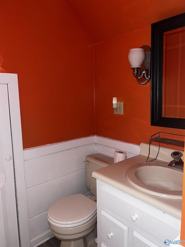 1727 SW Chestnut Mountain Rd, Decatur, AL 35603 - bathroom featuring vanity, toilet, wainscoting, and lofted ceiling