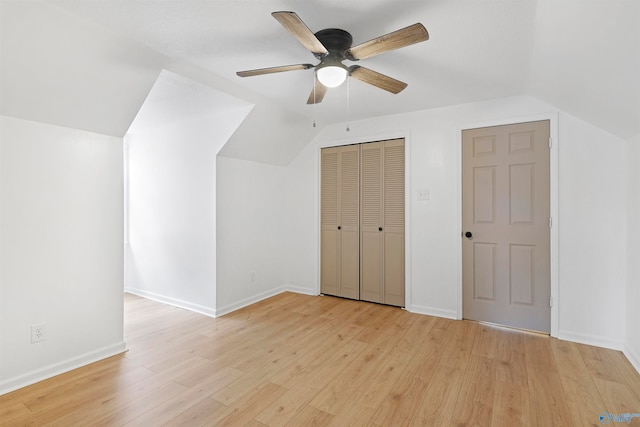 bonus room with light wood-type flooring, vaulted ceiling, and ceiling fan