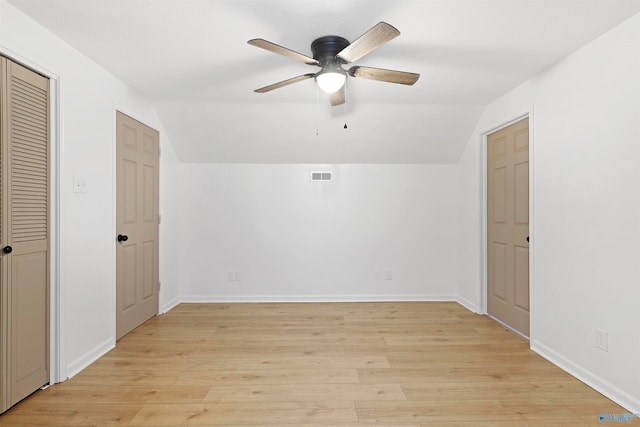 unfurnished room featuring light wood-type flooring, lofted ceiling, and ceiling fan