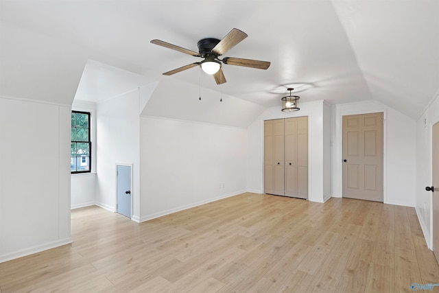 additional living space with ceiling fan, light wood-type flooring, and lofted ceiling