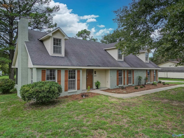 cape cod home with a front lawn