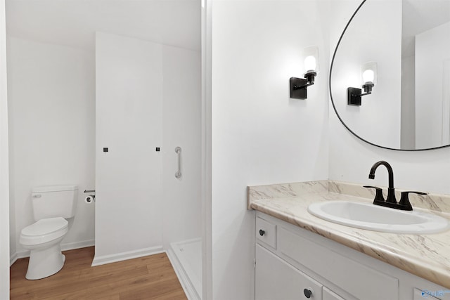 bathroom with vanity, hardwood / wood-style floors, and toilet