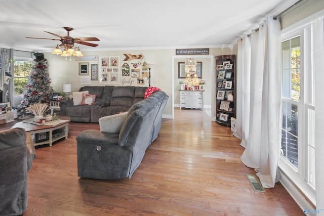 living room featuring ceiling fan, wood-type flooring, and crown molding