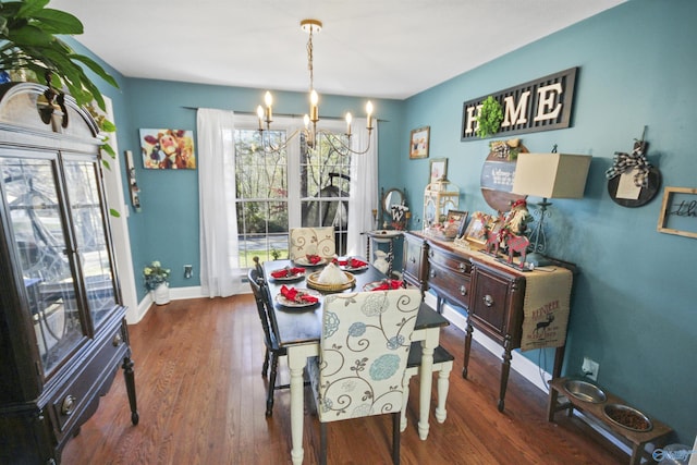 dining area with a chandelier and dark hardwood / wood-style flooring