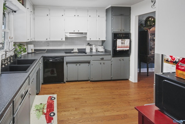 kitchen with black appliances, light hardwood / wood-style floors, gray cabinets, and sink