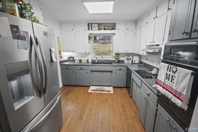 kitchen featuring gray cabinets, sink, black appliances, and light wood-type flooring