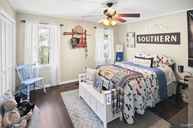 bedroom featuring ceiling fan, a closet, dark hardwood / wood-style floors, and ornamental molding