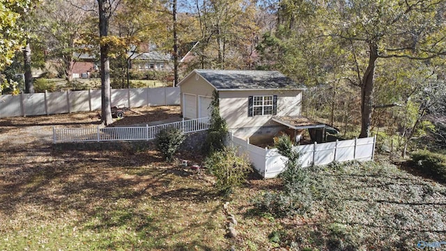 view of side of home featuring a garage and an outdoor structure