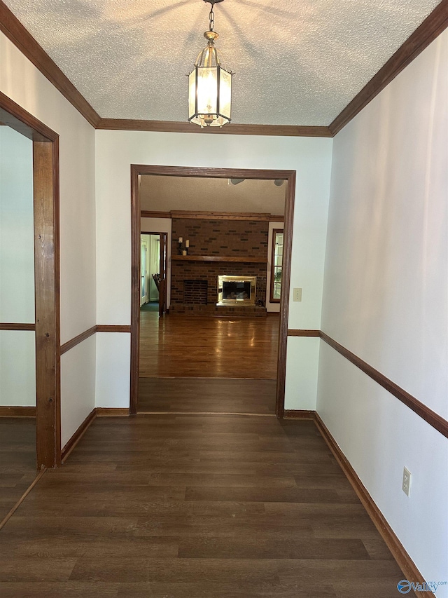 2008 Oakleaf Ln, Arab, AL 35016 - hallway featuring ornamental molding, dark wood finished floors, and a textured ceiling