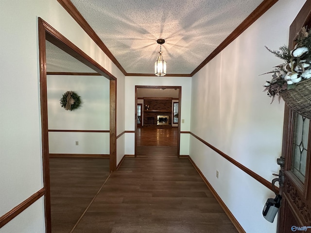 2008 Oakleaf Ln, Arab, AL 35016 - hallway with crown molding, a textured ceiling, baseboards, and dark wood-style floors