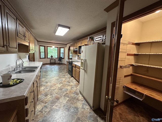 2008 Oakleaf Ln, Arab, AL 35016 - kitchen with stone finish floor, a textured ceiling, a sink, light countertops, and black appliances