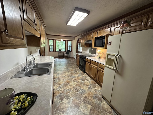 2008 Oakleaf Ln, Arab, AL 35016 - kitchen featuring light countertops, under cabinet range hood, a sink, stone finish flooring, and black appliances
