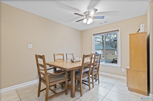 dining room featuring light tile patterned flooring, a textured ceiling, and ceiling fan