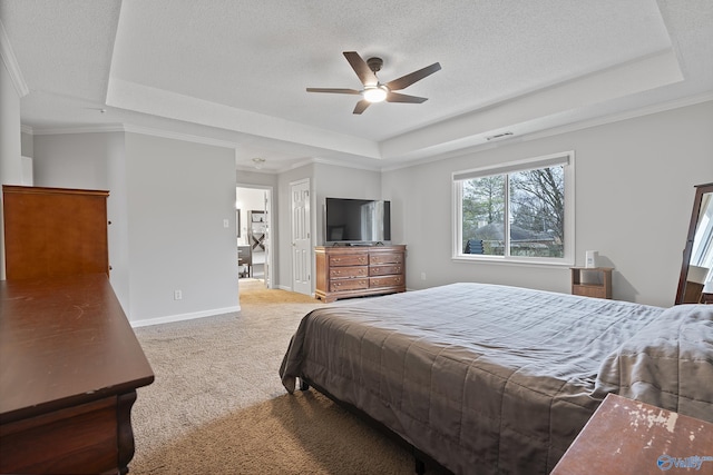 carpeted bedroom with ceiling fan, ornamental molding, a raised ceiling, and a textured ceiling