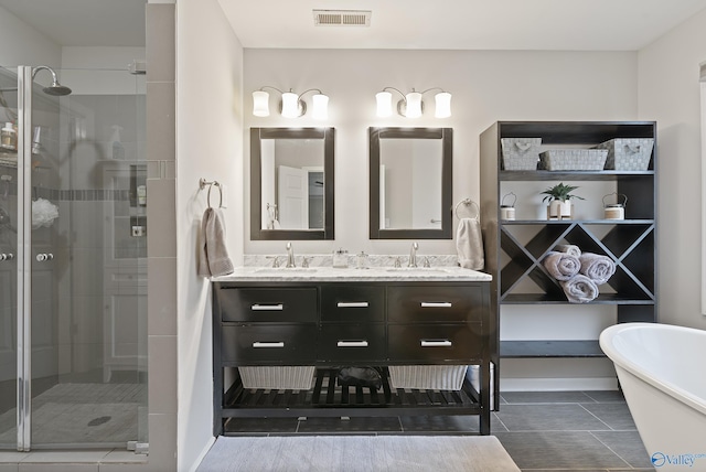 bathroom featuring vanity and independent shower and bath