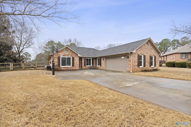 ranch-style home with a garage and a front yard