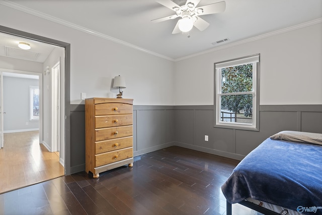 bedroom with multiple windows, ornamental molding, and dark hardwood / wood-style floors