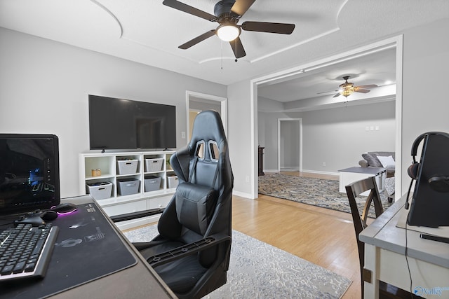 office area with ceiling fan and hardwood / wood-style floors