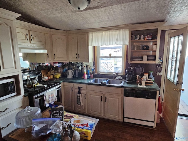 kitchen with a sink, under cabinet range hood, dark countertops, stainless steel electric range, and white dishwasher