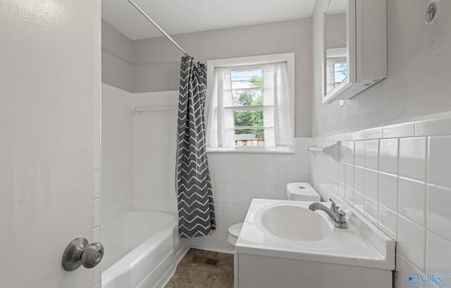 full bathroom with vanity, shower / tub combo, tile walls, and toilet