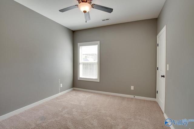 empty room featuring light carpet, baseboards, and visible vents